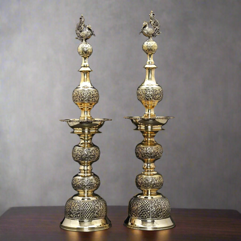 Brass peacock-lidded table lamps, ornate paired design, height 25 in
