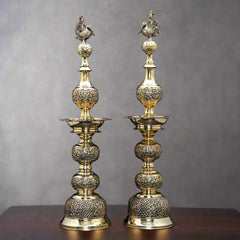Brass peacock-lidded table lamps, ornate paired design, height 25 in