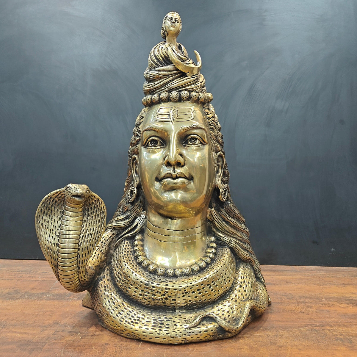 Brass Shiva head bust with moon and Ganga river, cobra-like hood at left