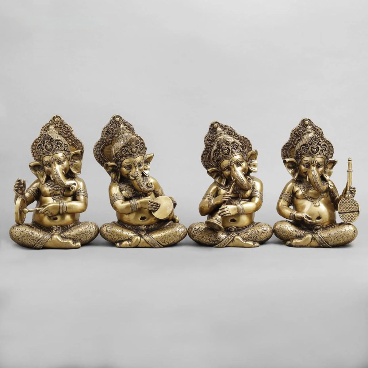 Brass Ganesh musicians set, four seated figures with patterned crowns and instruments