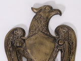 Close-up of vintage brass eagle door knocker face and wing details