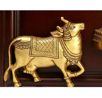 Gold-toned decorative cow figure wall ornament with patterned saddle, in wooden frame