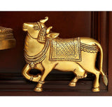 Gold decorative cow figure wall ornament with ornate harness, mounted in wooden frame