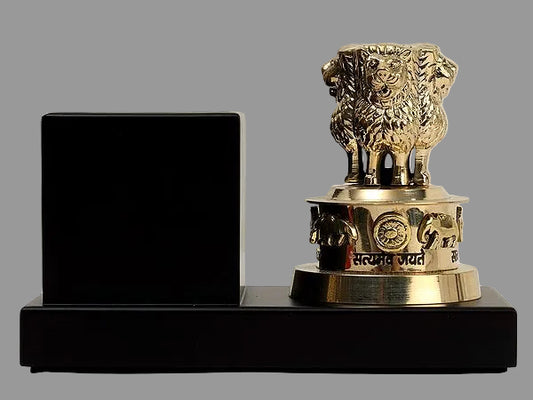 Brass lion statue on wooden pen stand with engraved band, dark base, no pens visible