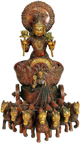 Brass Surya statue front view, raised arms holding lamps atop carousel of small horses