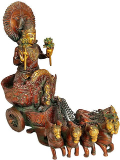 Brass Surya statue side angle, seated deity with crown, holding lamp over horse team