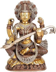 Brass statue of Goddess Saraswati seated, holding veena, ornate crown and jewelry