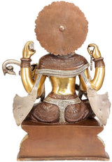 Brass Saraswati statue back view with large halo, carved garments and seated pose