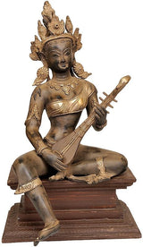 Brass Saraswati figurine seated on wooden pedestal with veena, 13 in