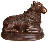Handcrafted brass bull vahana statue with detailed saddle and ornate patterns, side view