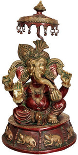 Large brass Lord Ganesha idol with umbrella, red accents, seated pose, ornate base