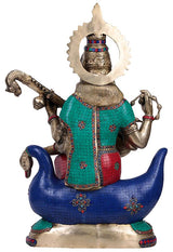 Rear view of brass Saraswati idol on swan, colorful inset panels and raised arms