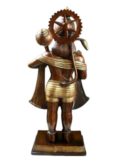Brass Hanuman statue viewed from rear, crown and shoulder mace, on square base.