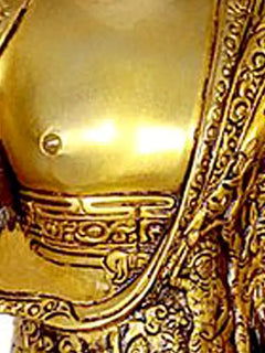 Buddha brass statue torso with detailed robe patterns and golden finish