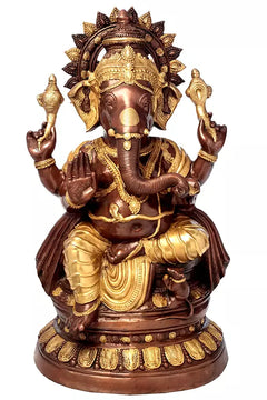 Large brass Ganesha sculpture with four arms, ornate crown, and golden details.