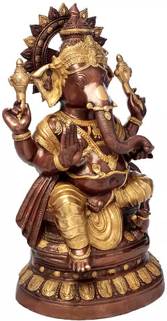Brass Ganesha statue side view with raised hands, jeweled crown, and gold accents.