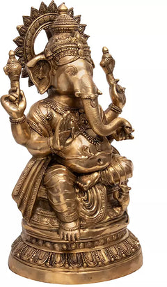 Brass Ganesha statue side view, detailed crown, earrings, and draped lower attire