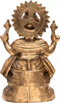 Back view of large brass Ganesha sculpture with circular halo and ornamented base