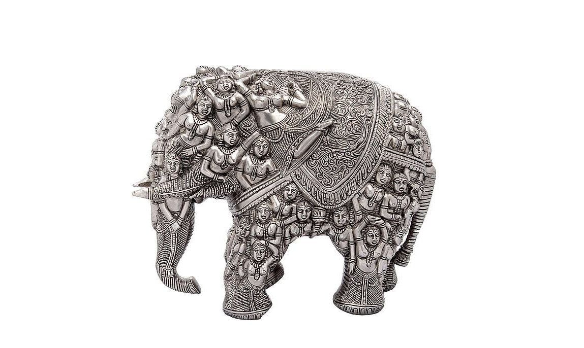 Silver brass elephant statue with intricate relief figures on back