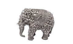 Silver brass elephant statue with intricate relief figures on back