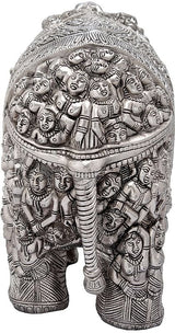 Silver brass elephant statue close-up with clustered carved faces and figures