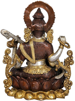 Back view Saraswati brass statue with arched halo, raised arms, veena and lotus base