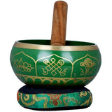 Tibetan singing bowl with green body, gold Ashtamangala symbols, and wooden mallet