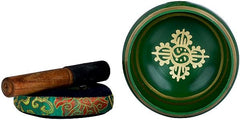 Tibetan singing bowl and wooden mallet; gold emblem on green brass surface