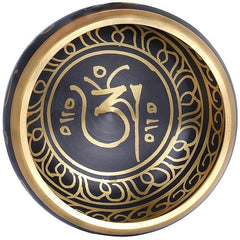 Top view of dark blue singing bowl with gold Om and Tibetan-style patterns