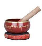 Red brass Tibetan singing bowl with gold script, wooden mallet and padded base
