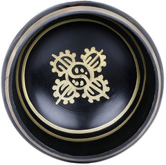 Inside view of black Tibetan singing bowl with gold emblem