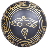 Black brass singing bowl exterior with golden circular pattern and central motif