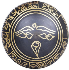 Black brass singing bowl exterior with golden circular pattern and central motif