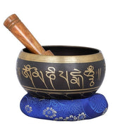 Brass singing bowl with mantras and blue patterned cushion, 6.5 in height
