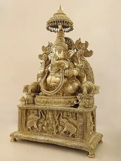 Brass Ganesha and Gaja Lakshmi sculpture, ornate pedestal, angled view