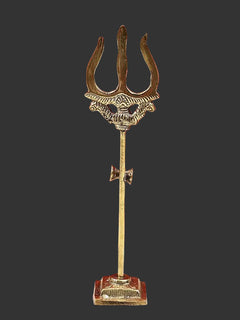 Brass small trishul upright on rectangular base, three prongs and carved crown