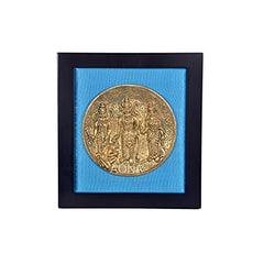 Framed brass Ram Darbar plate with blue textured backing in a wooden frame.