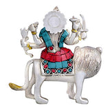 Seated deity on lion figurine, teal outfit and red skirt with jeweled belt