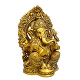 Handcrafted brass Ganesha idol, side view showing multiple arms and detailed jewelry